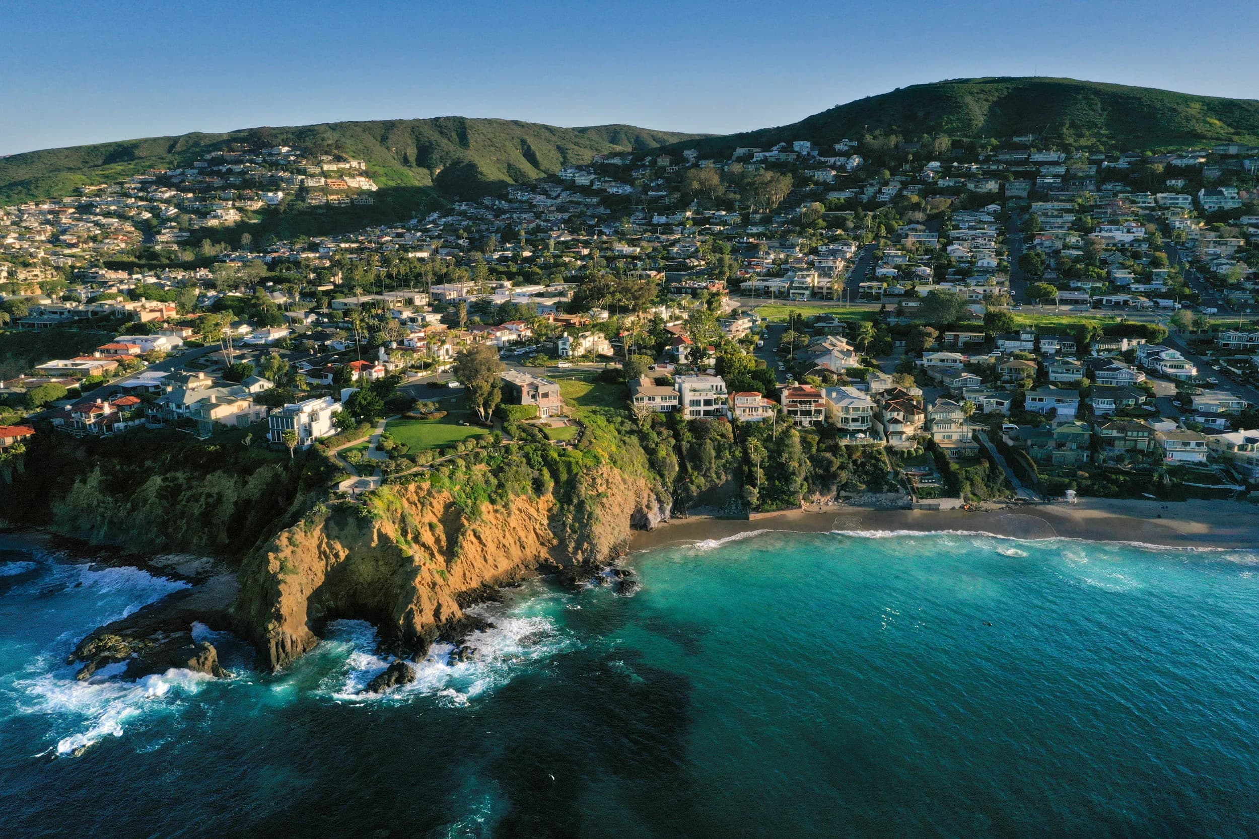 Aerial view of ocean waves breaking along a rocky coastline