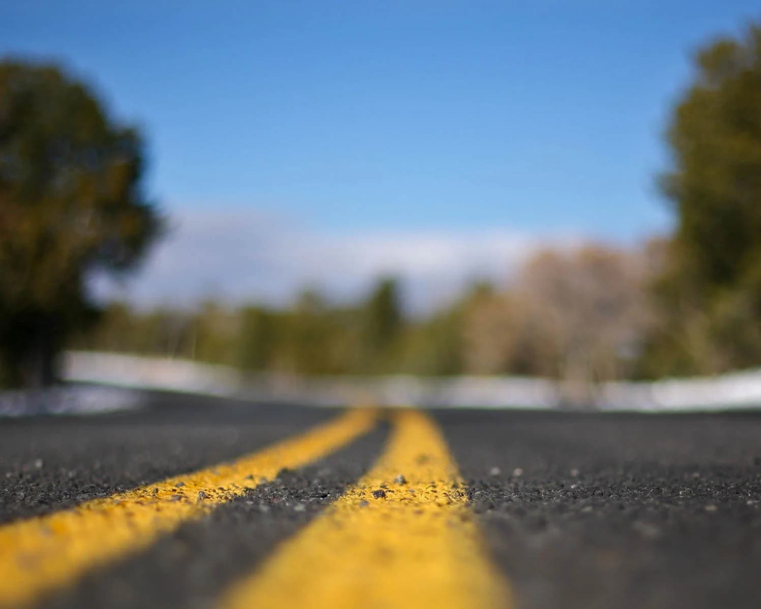 An open road with yellow center lines stretching toward the horizon